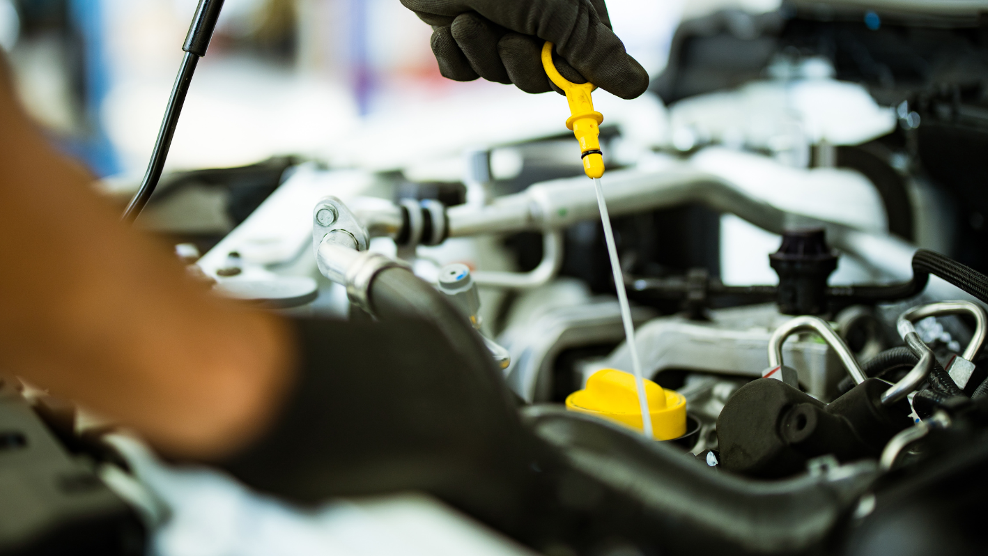 A man is working on a car engine