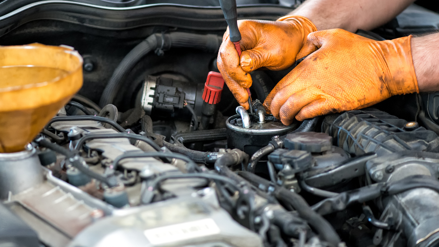 A man is working on a car engine