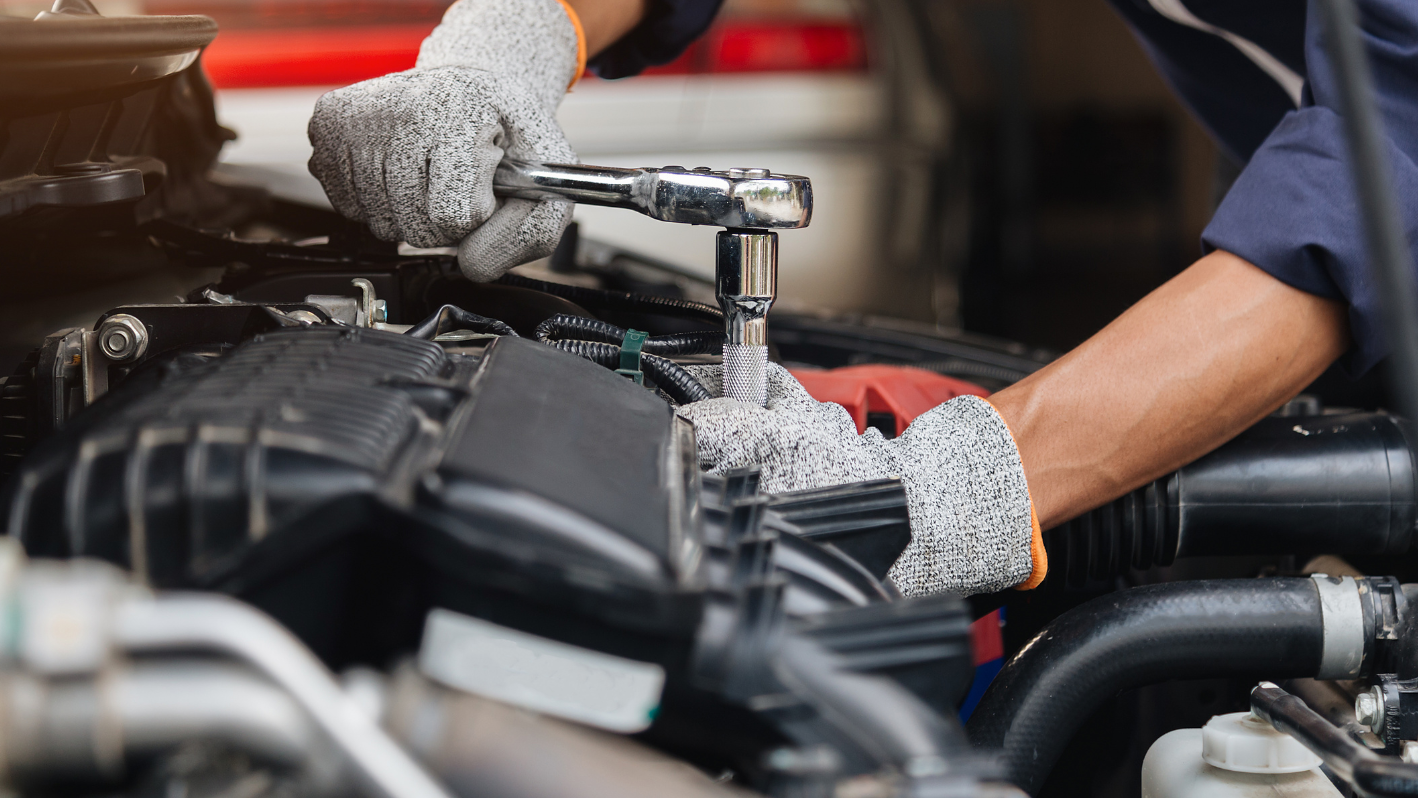 A mechanic working on a car engine